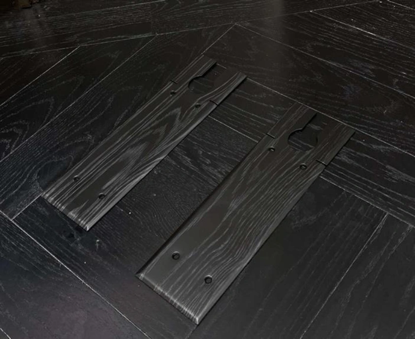 Two dark wood planks on herringbone floor