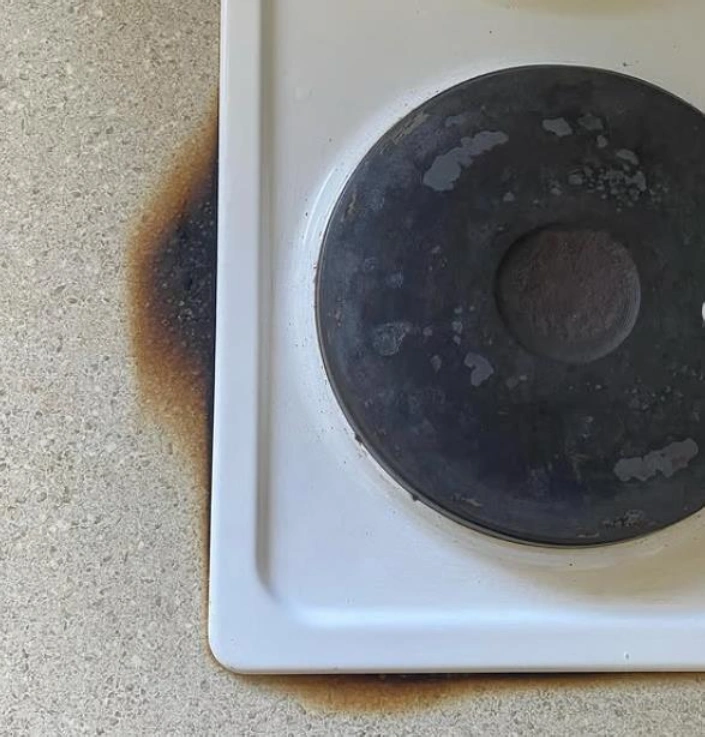 Scorched stove burner on kitchen surface
